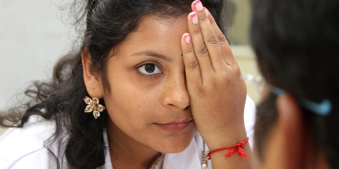 Woman covers her eye with her hand