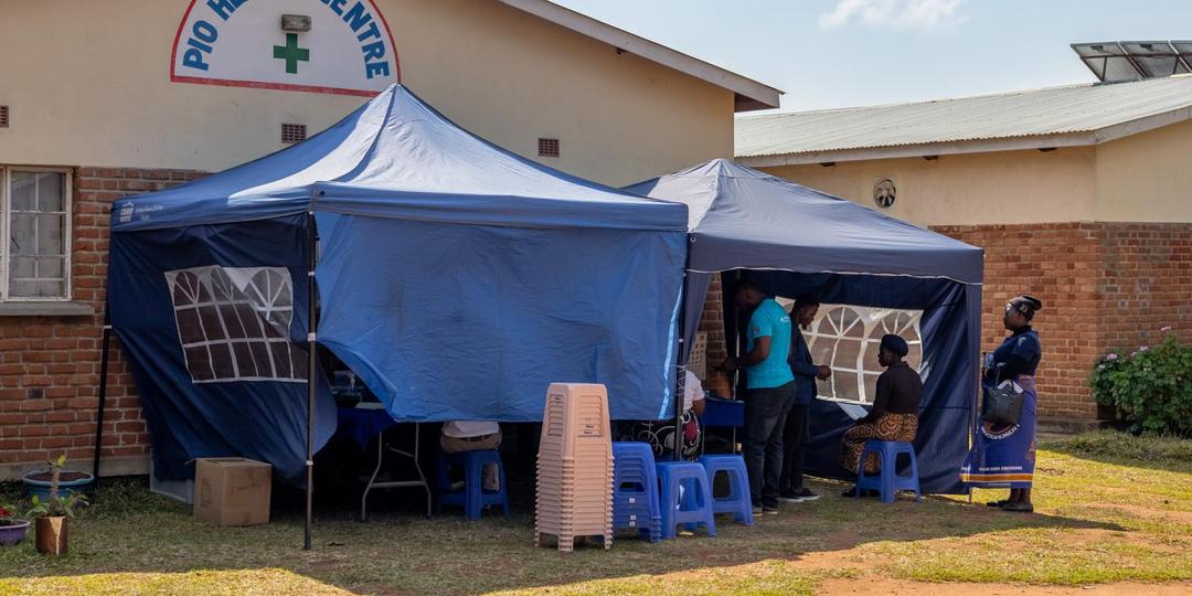 Health center with two blue pavilions in front of it